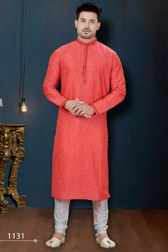 Coral-pink kurta with a subtle along the collar,placket and cuffs,paired with white trousers.