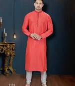 Coral-pink kurta with a subtle along the collar,placket and cuffs,paired with white trousers.