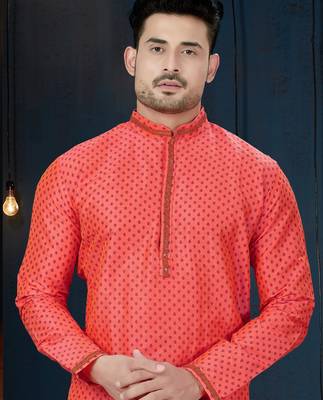 Coral-pink kurta with a subtle along the collar,placket and cuffs,paired with white trousers. 2