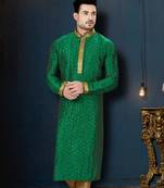 Emerald-green kurta with subtle gold motifs, finished with a gold-trimmed band collar with gold trousers.