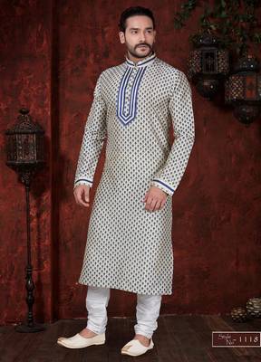 Cream kurta with an all-over blue motif, finished with a bold embroidered placket and matching cuff accents; styled 1