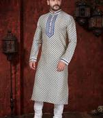 Cream kurta with an all-over blue motif, finished with a bold embroidered placket and matching cuff accents; styled