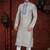 Cream kurta with an all-over blue motif, finished with a bold embroidered placket and matching cuff accents; styled