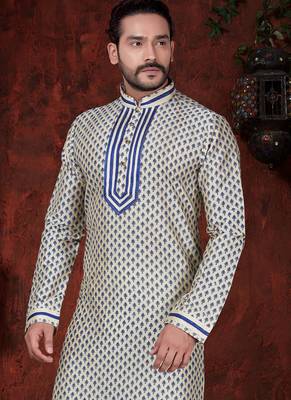 Cream kurta with an all-over blue motif, finished with a bold embroidered placket and matching cuff accents; styled 2