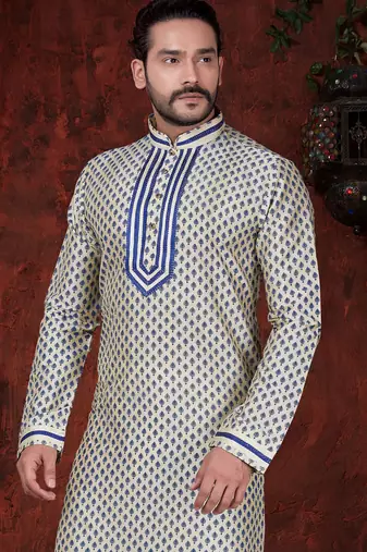 Cream kurta with an all-over blue motif, finished with a bold embroidered placket and matching cuff accents; styled