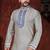 Cream kurta with an all-over blue motif, finished with a bold embroidered placket and matching cuff accents; styled