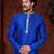 Royal-blue kurta with cream-and-blue floral detailing on the band collar and placket, paired