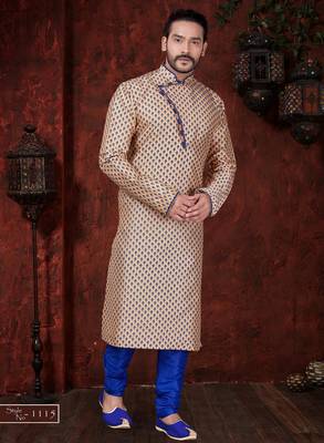 Peach kurta with blue motifs and an asymmetrical neckline, paired with royal-blue trousers— festive wear 1