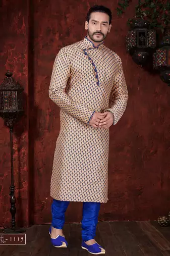 Peach kurta with blue motifs and an asymmetrical neckline, paired with royal-blue trousers— festive wear
