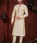 Fawn kurta set with elegant coral-red patterned trim on the collar, placket, and cuffs—simple festive wear