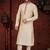 Fawn kurta set with elegant coral-red patterned trim on the collar, placket, and cuffs—simple festive wear