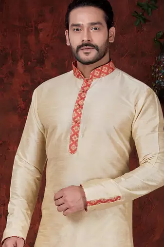 Fawn kurta set with elegant coral-red patterned trim on the collar, placket, and cuffs—simple festive wear