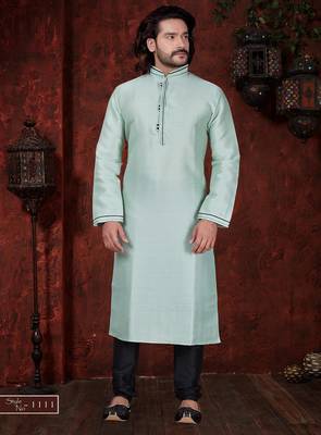Mint-green kurta with subtle dark piping, paired with black trousers—clean, understated festive style. 1