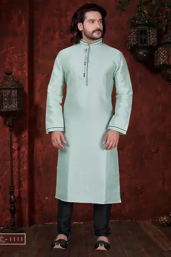 Mint-green kurta with subtle dark piping, paired with black trousers—clean, understated festive style.