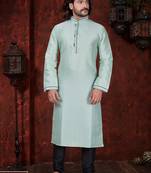 Mint-green kurta with subtle dark piping, paired with black trousers—clean, understated festive style.