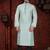 Mint-green kurta with subtle dark piping, paired with black trousers—clean, understated festive style.