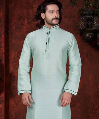 Mint-green kurta with subtle dark piping, paired with black trousers—clean, understated festive style. 2