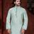 Mint-green kurta with subtle dark piping, paired with black trousers—clean, understated festive style.