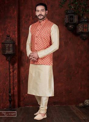 Coral-red and gold patterned nehru jacket paired with an ivory kurta and trousers—an elegant festive ensemble. 1