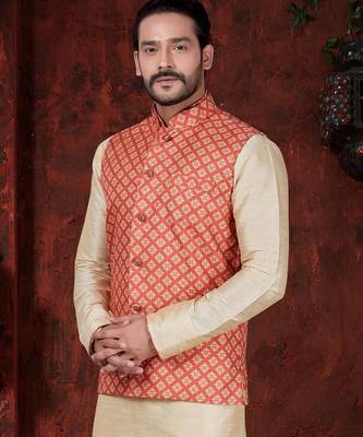 Coral-red and gold patterned nehru jacket paired with an ivory kurta and trousers—an elegant festive ensemble. 2