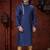 Blue kurta with elegant gold trim, paired with gold trousers—simple, refined festive style.
