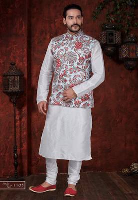 White kurta set with a richly patterned floral nehru jacket in red, blue, and gold—perfect for festive occasions. 1