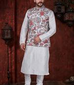 White kurta set with a richly patterned floral nehru jacket in red, blue, and gold—perfect for festive occasions.
