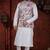 White kurta set with a richly patterned floral nehru jacket in red, blue, and gold—perfect for festive occasions.