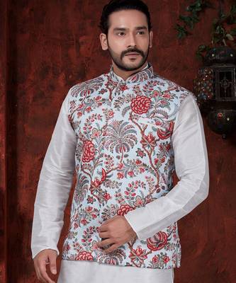 White kurta set with a richly patterned floral nehru jacket in red, blue, and gold—perfect for festive occasions. 2