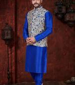 Royal-blue kurta set with a cream floral nehru jacket featuring blue detailing—an elegant festive look.