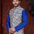 Royal-blue kurta set with a cream floral nehru jacket featuring blue detailing—an elegant festive look.