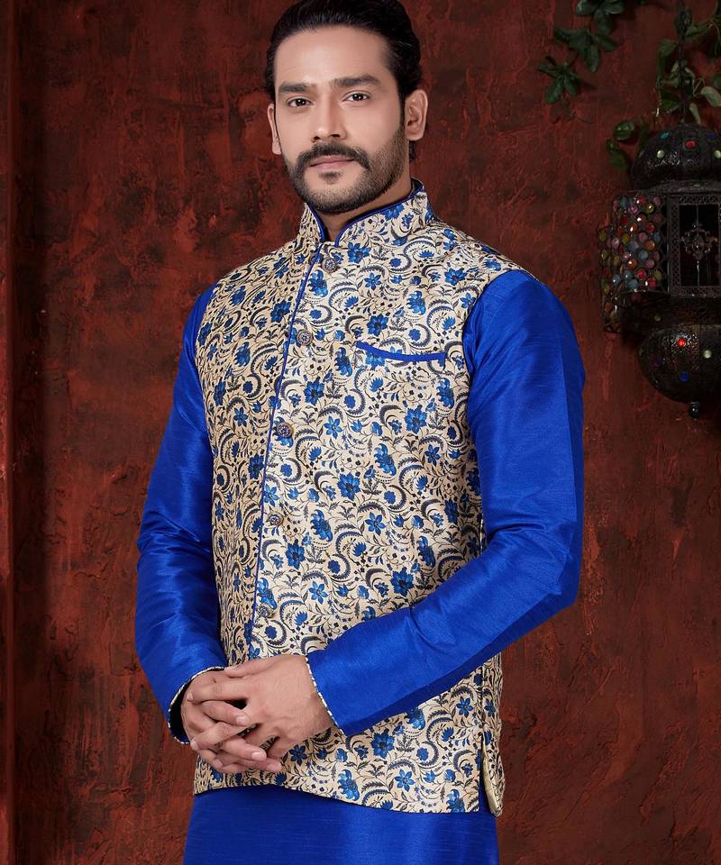 Royal-blue kurta set with a cream floral nehru jacket featuring blue detailing—an elegant festive look.