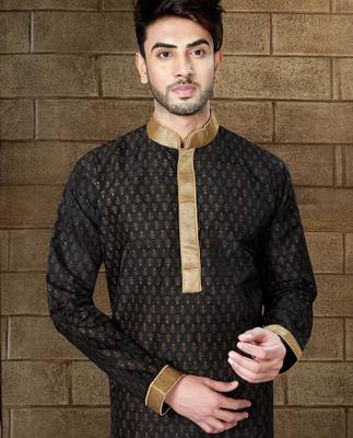 Black kurta with subtle gold motifs and gold-trimmed detailing, paired with brown trousers --an elegant festive wear 2
