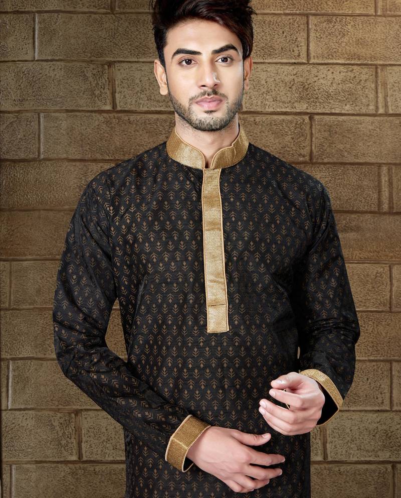 Black kurta with subtle gold motifs and gold-trimmed detailing, paired with brown trousers --an elegant festive wear