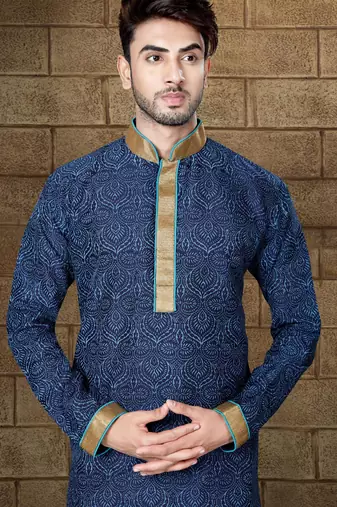 Navy patterned kurta with gold trim paired with brown trousers—an elegant festive ensemble.