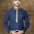 Navy patterned kurta with gold trim paired with brown trousers—an elegant festive ensemble.