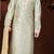 Off white printed kurta with gold-trimmed detailing, paired with gold trousers—an elegant festive look.