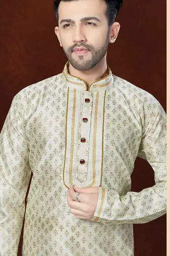 Off white printed kurta with gold-trimmed detailing, paired with gold trousers—an elegant festive look.