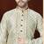 Off white printed kurta with gold-trimmed detailing, paired with gold trousers—an elegant festive look.