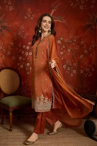 Rust color smart and ethnic silk fabric embroidered partywear suit