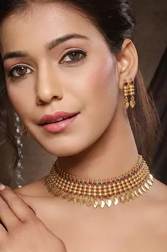 Gold plated temple necklace set with multicolor stones and matching earrings