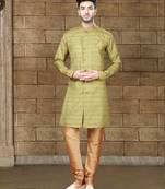 Olive-green indo-western sherwani with an asymmetrical placket—ideal for weddings.