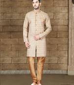 Beige textured sherwani with gold buttons and matching pocket square—perfect for weddings.