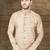 Beige textured sherwani with gold buttons and matching pocket square—perfect for weddings.