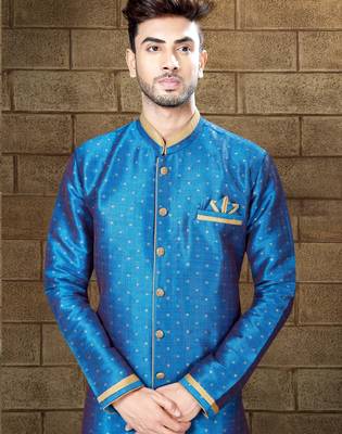 Royal-blue sherwani with gold accents and matching pocket square—ideal for celebrations. 2