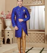 Royal-blue sherwani with gold motifs, asymmetrical front,—perfect for celebrations.