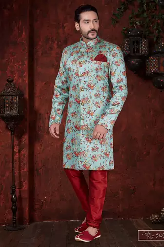 Aqua floral sherwani with gold buttons, maroon pocket square, and matching trousers.