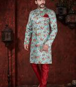 Aqua floral sherwani with gold buttons, maroon pocket square, and matching trousers.