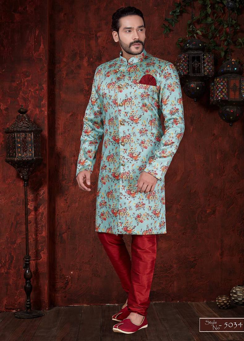 Aqua floral sherwani with gold buttons, maroon pocket square, and matching trousers.