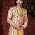 Cream floral sherwani with asymmetrical jacket, gold accents—ideal for weddings.